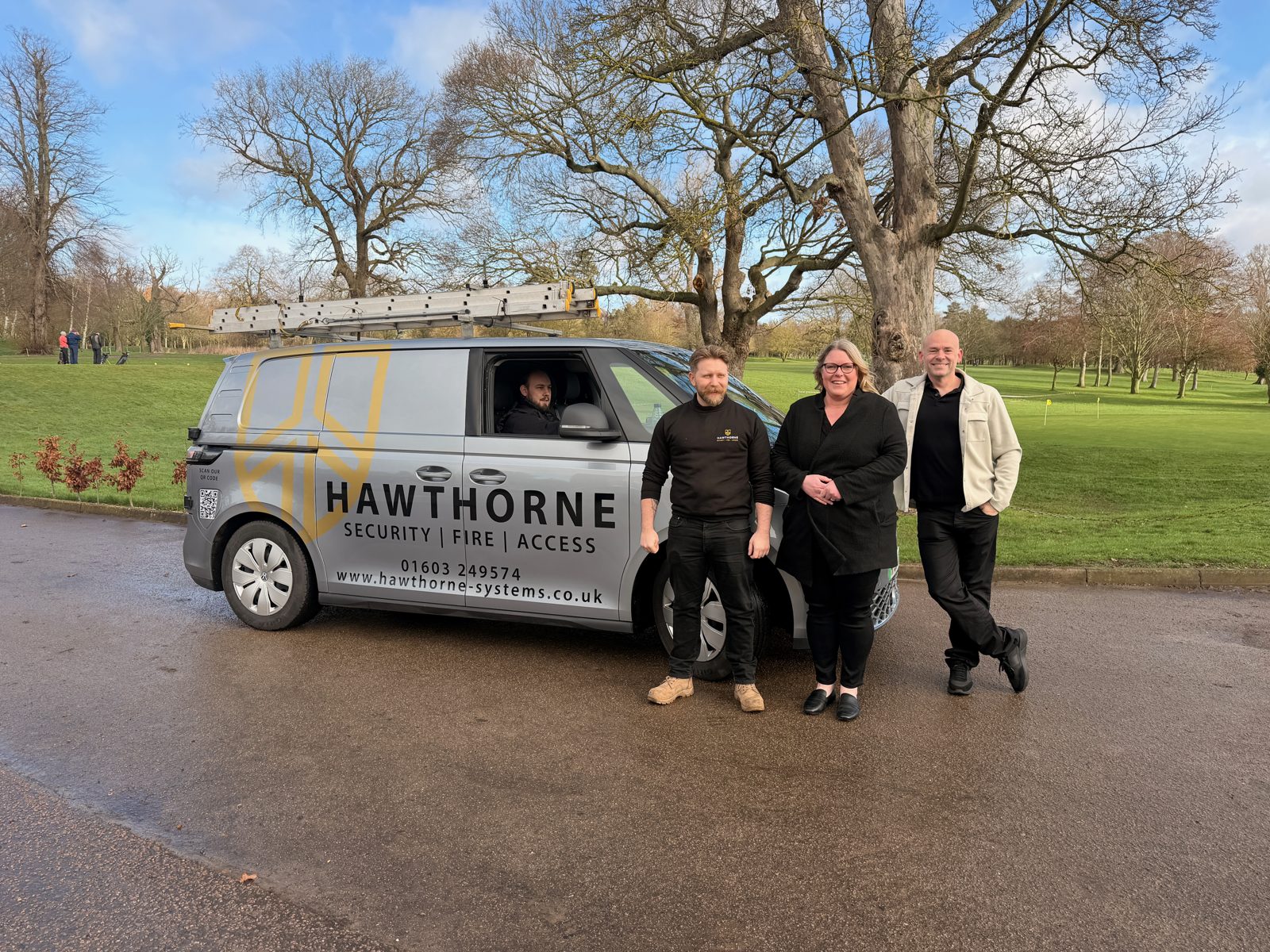 Hawthorne team members standing beside a Hawthorne van